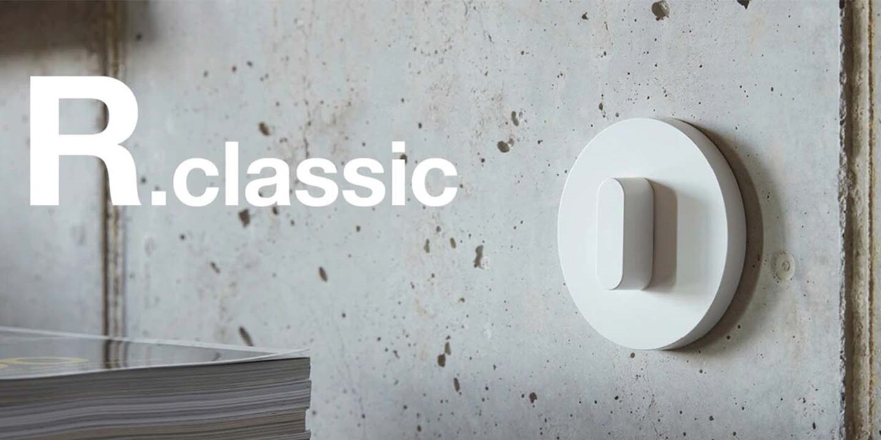 White R.classic series rotary light dimmer switch mounted on concrete wall