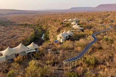 Eco-friendly luxury tented camp with solar panels in a wilderness area